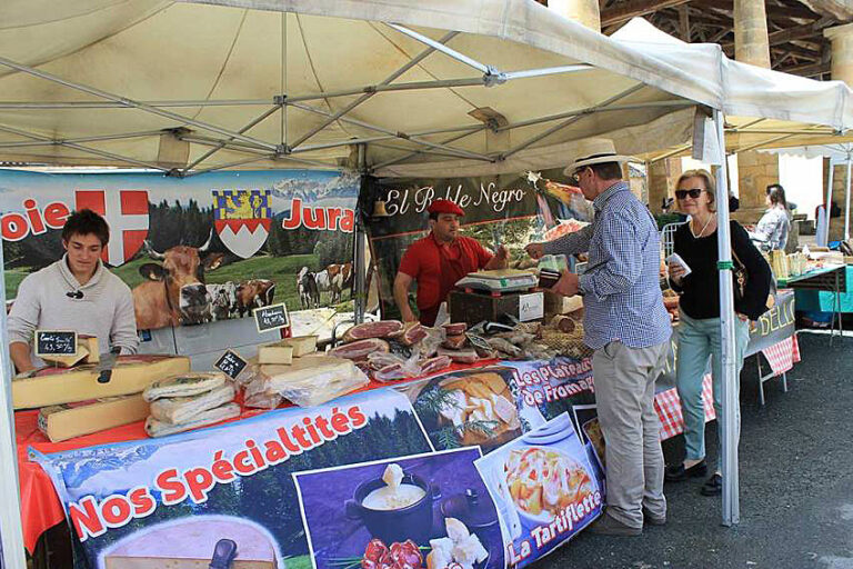 Selection of local French cheeses and dairy products artfully arranged on market display table