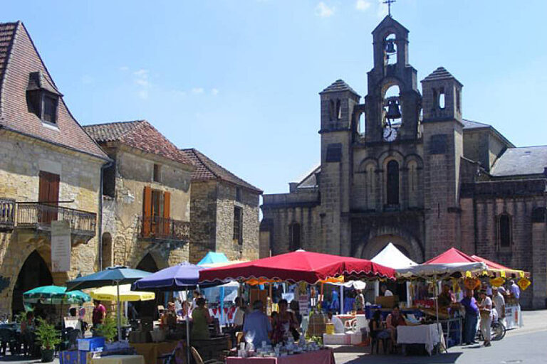Interior view of Market Halle showing merchants and customers at various food vendor stalls